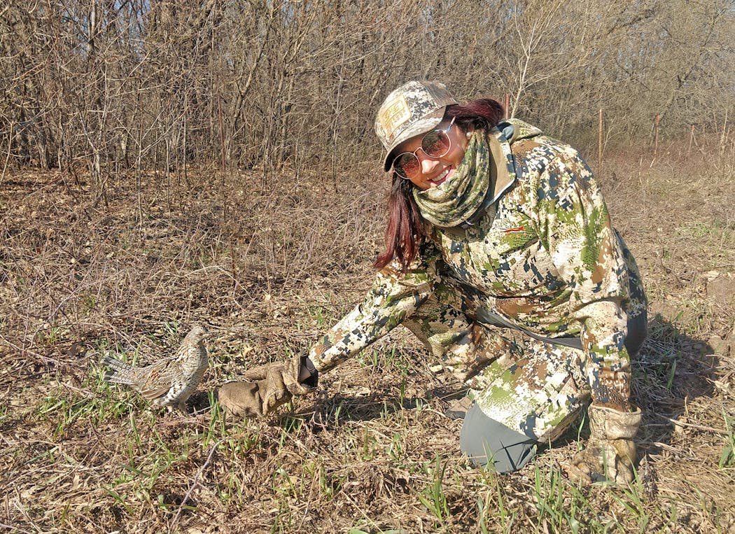 Patti Beasley of Indianapolis, Ind., a hunting partner of Bill Marchel’s, with a ruffed grouse that Beasley and Marchel named Doofus after encountering the bird while turkey hunting this spring.