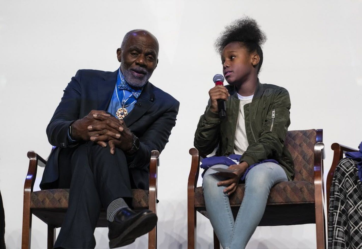 Retired Justice Alan Page listened to a question by Junior Page Scholar E'Rayah Shaw during a celebration for Page at Justice Page Middle School after he received the Medal of Freedom on November 19, 2018 in Minneapolis, Minn.