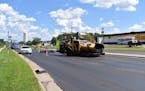 Crews work on Excelsior Boulevard in Hopkins, where Hennepin County and Cargill are testing a new asphalt mix.