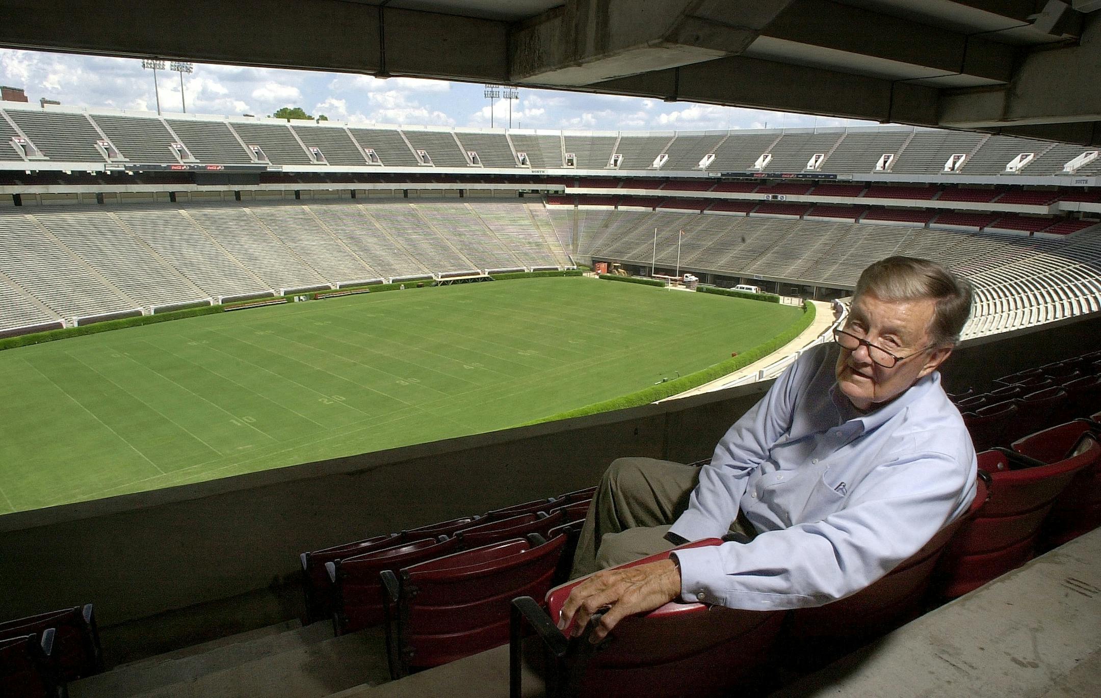 In this Aug. 19, 2002 file photo, Larry Munson, the play-by play announcer for the Georgia Bulldogs, sits at Sanford Stadium in Athens, Ga. The 85-year-old Munson on Monday, Sept. 22, 2008 announced that he has retired, effective immediately. He said he owes Georgia fans "so much more than I can give."