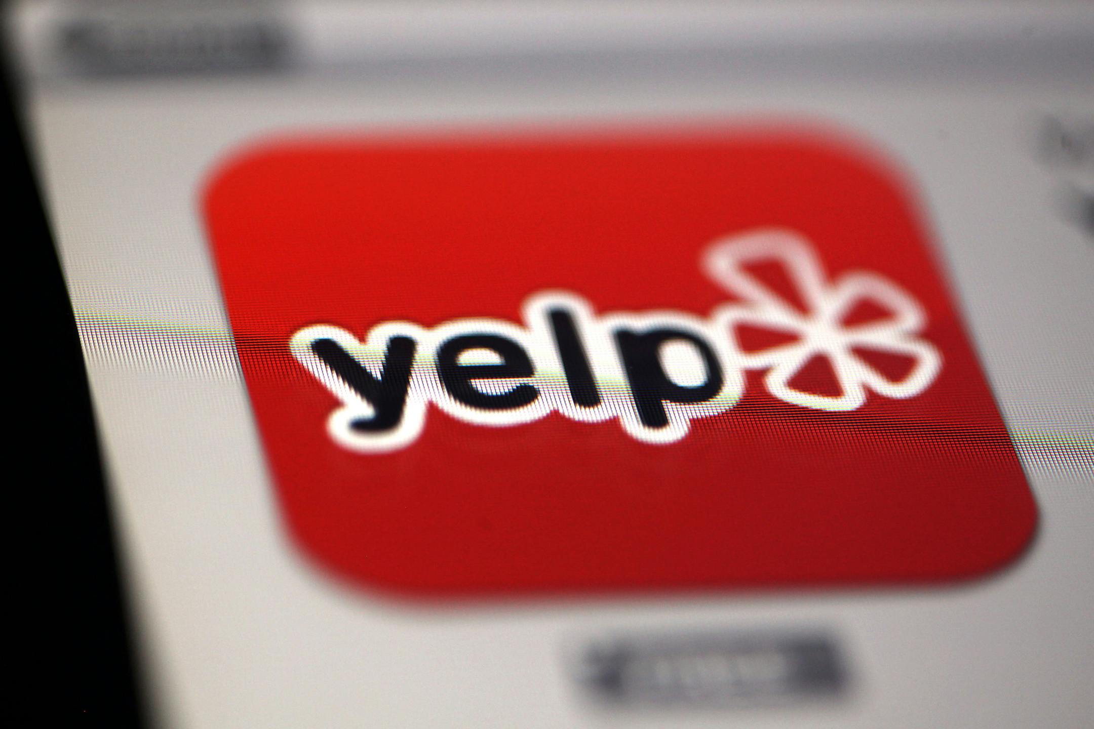 The Yelp Inc. app logo is displayed on an Apple Inc. iPad in Des Plaines, Illinois, U.S., on Tuesday, Feb. 5, 2013. Yelp Inc., owner of a website that lets consumers review local businesses, slipped after posting a wider quarterly loss than analysts estimated as it boosted spending on expansion into new markets. Photographer: Tim Boyle/Bloomberg