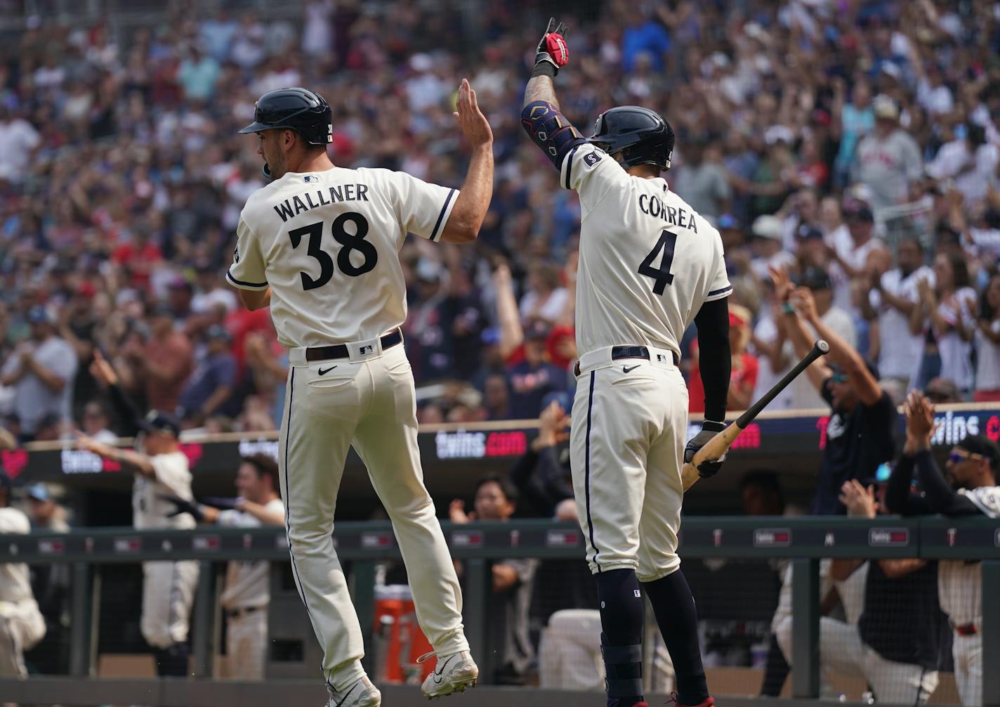 Minnesota Twins right fielder Matt Wallner (38) comes in to score in the 9th inning and celebrates with Minnesota Twins shortstop Carlos Correa (4) as in Minneapolis, Minn., on Sunday, July 23, 2023. Twins take on the White Sox at Target Field.] RICHARD TSONG-TAATARII • richard.tsong-taatarii @startribune.com