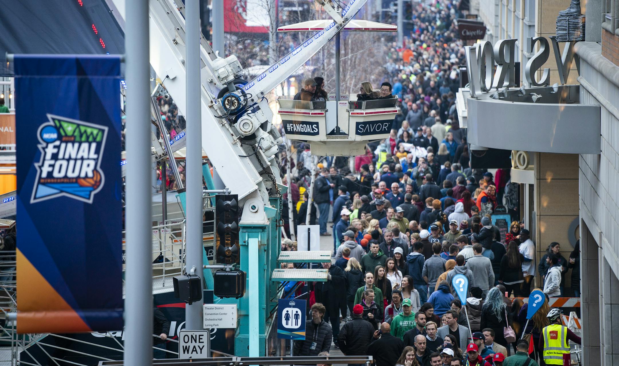 The scene on Nicollet Mall last month as people ride the ferris wheel at Tip-Off Tailgate.