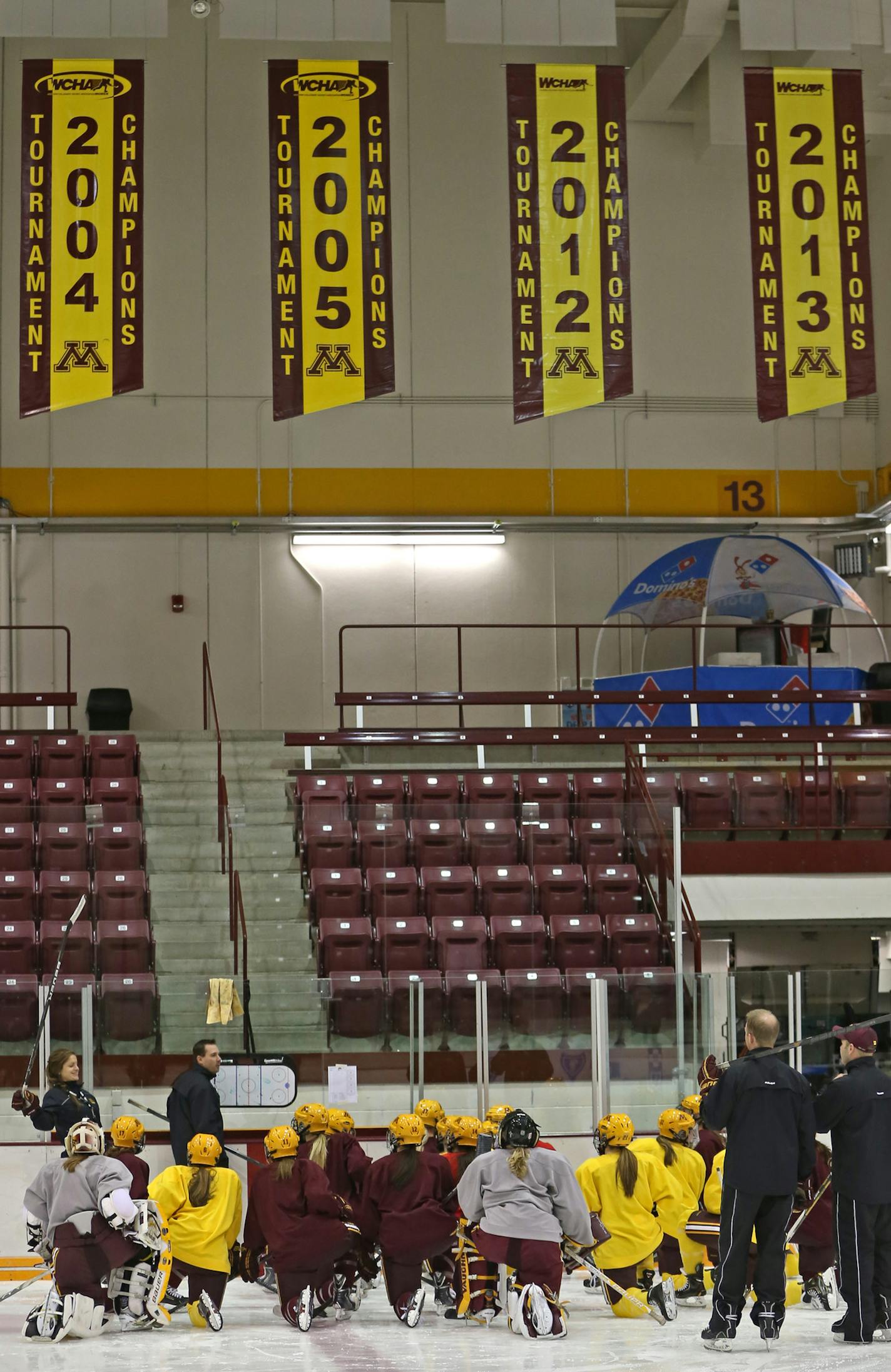 Members of the Gopher women's hockey team gathered under WCHA Tournament Champions banners during practice on 11/12/13.] Bruce Bisping/Star Tribune bbisping@startribune.com