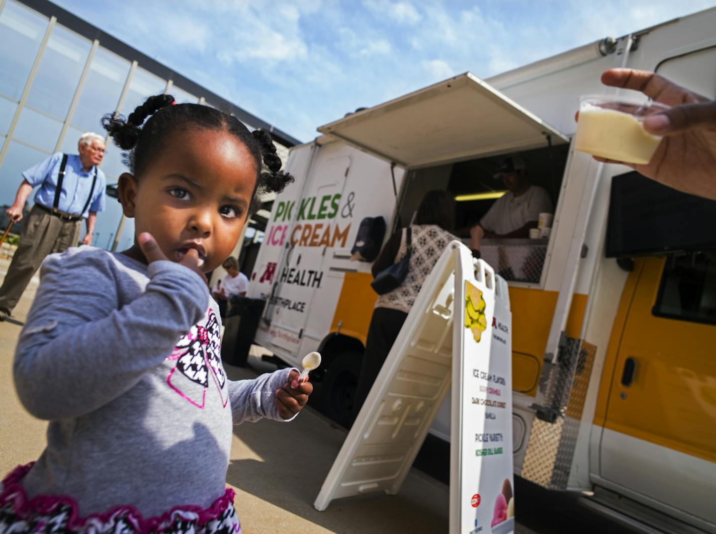 Outside the Fairview Maple Grove clinic, Salma Ibrahim enjoyed some ice cream which her mother got for her from "Pickles and Ice Cream" food truck.