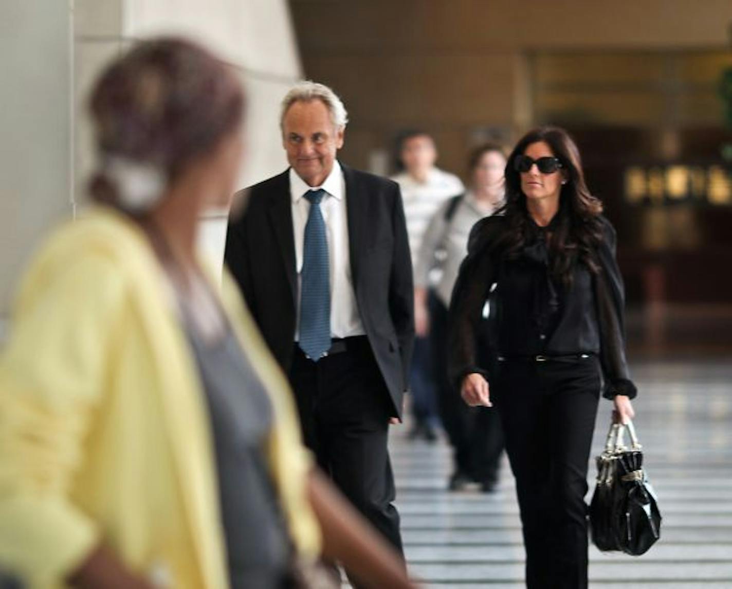 Nov. 22, 2010 - Denny Hecker walked with his then girlfriend, now wife Christi Rowan, as he left federal court in Minneapolis after pleading guilty to various fraud charges.