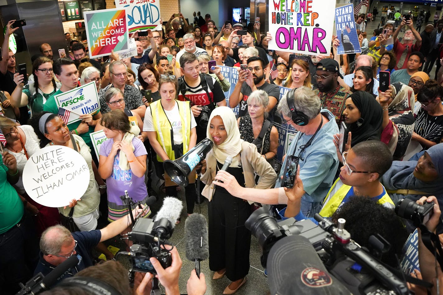 U.S. Rep. Ilhan Omar was greeted Thursday by more than 100 supporters cheering "Welcome Home Ilhan" as she arrived home to Minneapolis-St. Paul International Airport.