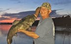 Brian Klawitter hoisted a dandy flathead catfish caught on the Mississippi. The fish weighed about 30 pounds.