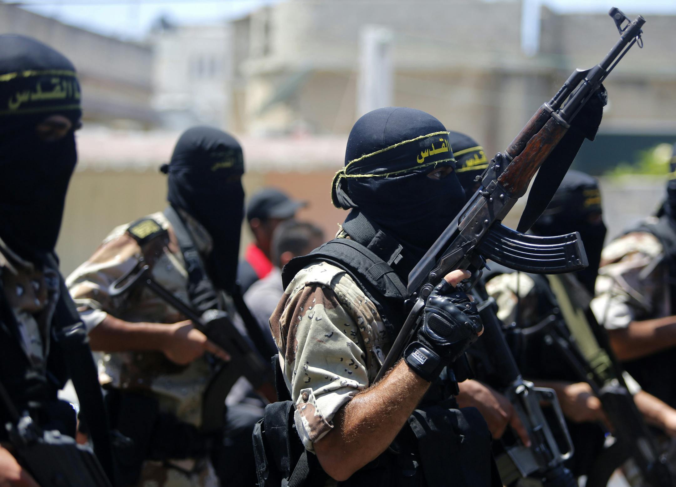 Masked militants of the Islamic Jihad group march during the funeral of their comrade Shaaban Al-Dahdouh, whose body was found under the rubble Tuesday, in Gaza City on Wednesday, Aug. 6, 2014. (AP Photo/Hatem Moussa)