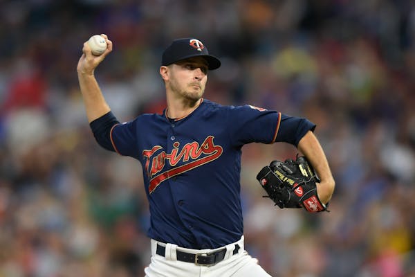 Minnesota Twins starting pitcher Jake Odorizzi (12) threw a pitch against the Cleveland Indians in the top of the first inning. ] Aaron Lavinsky • a