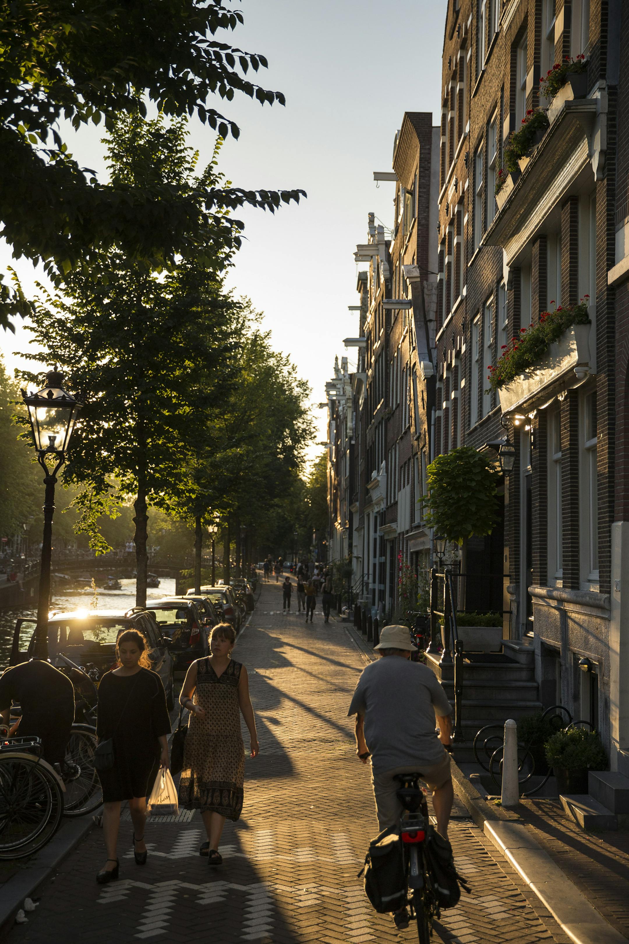 Old houses line the canals of Amsterdam&#x2019;s city center. Rent a bike and explore what the Dutch capital has to offer during a long weekend.