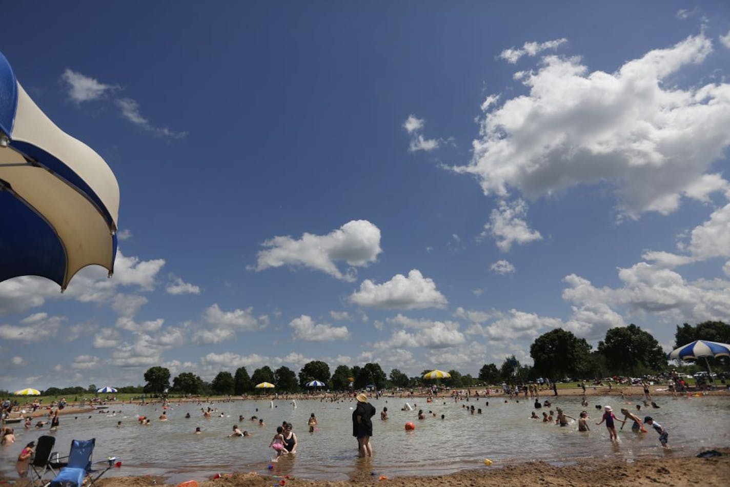 At the Lake Elmo Park Preserve swimming beach, hundreds of people enjoyed the weather on Memorial day .