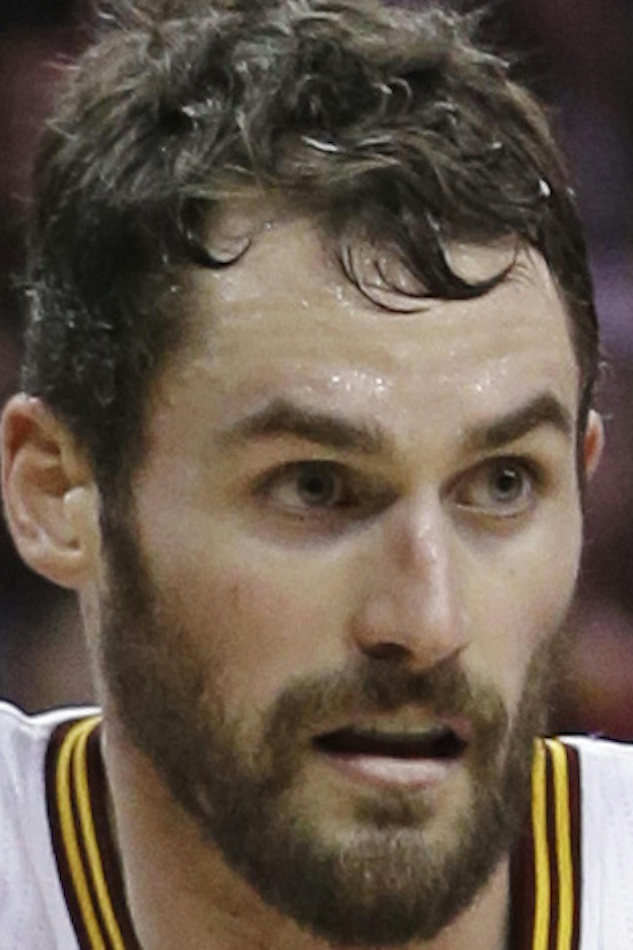 Cleveland Cavaliers' Kevin Love (0) drives past Brooklyn Nets’ Mirza Teletovic (33), from Bosnia, during the third quarter of an NBA basketball game Friday, Dec. 19, 2014, in Cleveland. The Cavaliers defeated the Nets 95-91. (AP Photo/Tony Dejak)