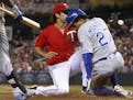 Kansas City Royals' Raul Mondesi, right, scores on a wild pitch by Minnesota Twins pitcher J.T. Chargois, left, during the sixth inning of a baseball 