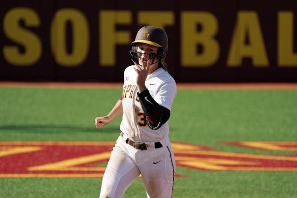 Gophers' Natalie Denhartog (31) rounded the bases after hitting a home run.