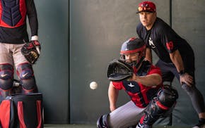 Tucker Frawley, minor league infield and catching coordinator for the Twins, gave pointers to catcher Brian O'Keefe on Thursday in Fort Myers, Fla.