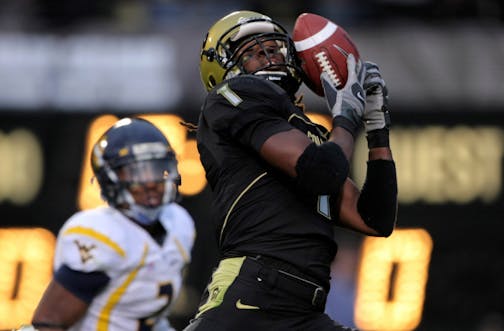 BOULDER, CO - SEPTEMBER 18: Wide receiver Josh Smith #1 of the Colorado Buffaloes makes a 38 yard touchdown reception to give the Buffs a 7-0 lead over the West Virginia Mountaineers in the first quarter at Folsom Field on September 18, 2008 in Boulder, Colorado. Ellis Lankster #2 of the West Virginia Mountaineers defends on the play.