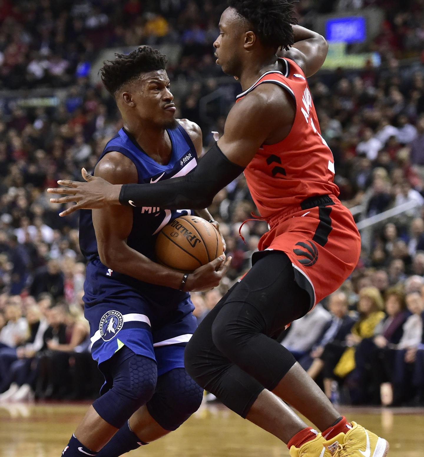 Minnesota Timberwolves guard Jimmy Butler (23) holds the ball as Toronto Raptors forward OG Anunoby (3) defends during second half NBA basketball action in Toronto on Wednesday, Oct. 24, 2018. (Frank Gunn/The Canadian Press via AP)