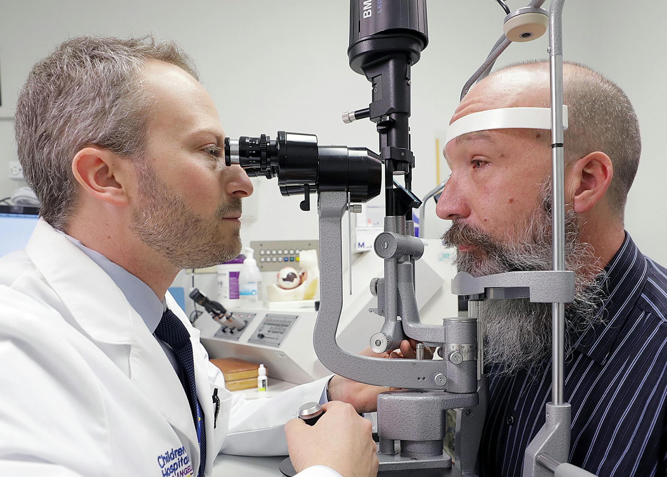 Dr. Aaron Nagiel, of The Vision Center at Children's Hospital Los Angeles, examines Seattle resident Toby Willis' right eye on the morning after Willis received his second gene-therapy treatment. Willis was the first adult to get the treatment since its approval, and hopes it will keep his progressive vision loss from getting worse, and perhaps lead to slight improvements. (Courtesy Children's Hospital Los Angeles) ORG XMIT: 1227636