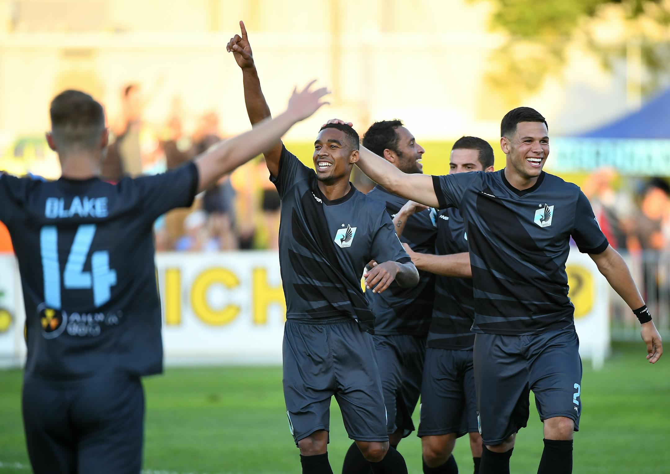 Minnesota United FC forward Stefano Pinho (11) celebrated with teammates including midfielder Jack Blake (14) and forward Christian Ramirez (21).