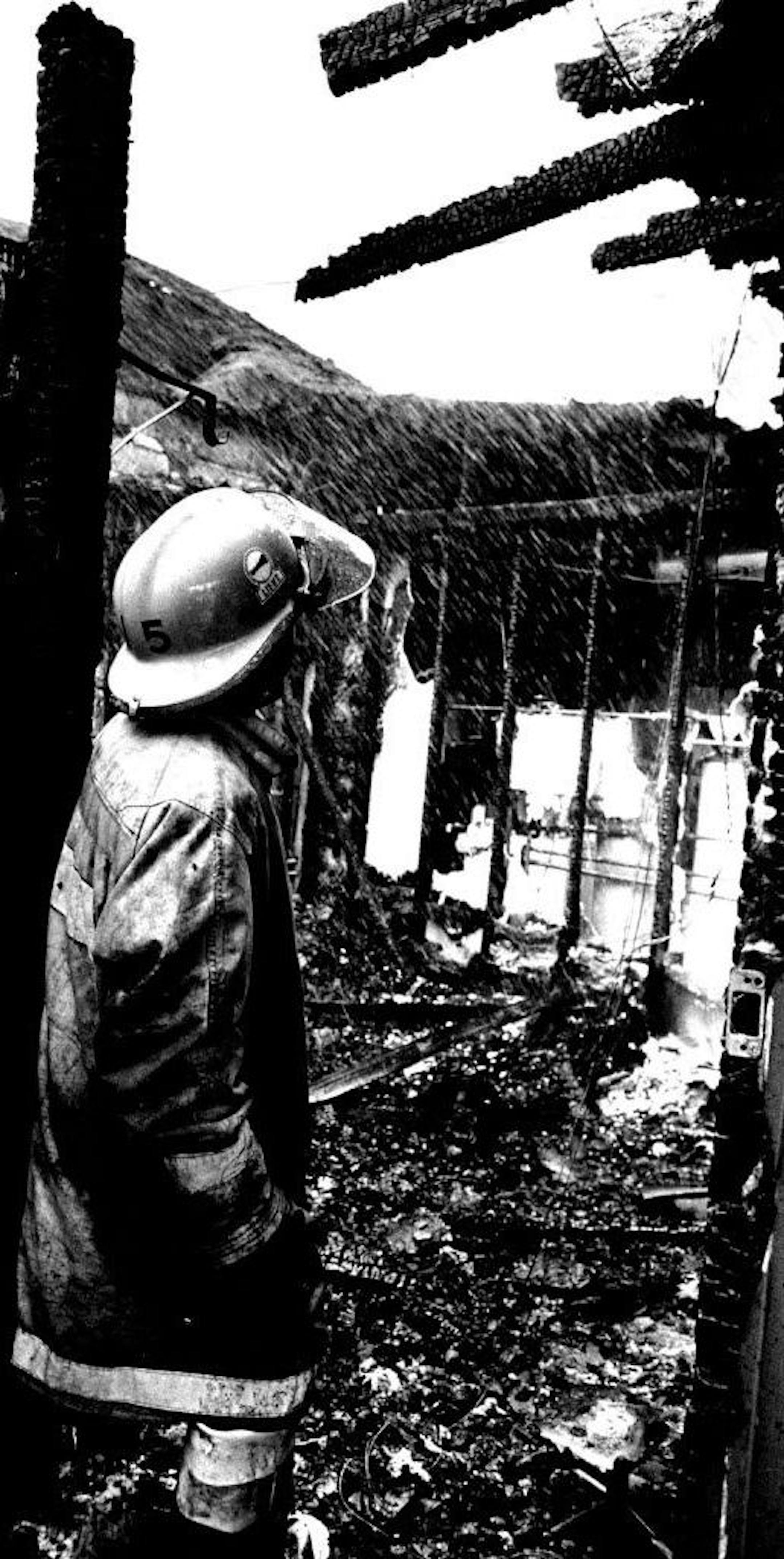 In this file photo, a Brainerd firefighter surveys the remains of a night club gutted by fire, north of the city.