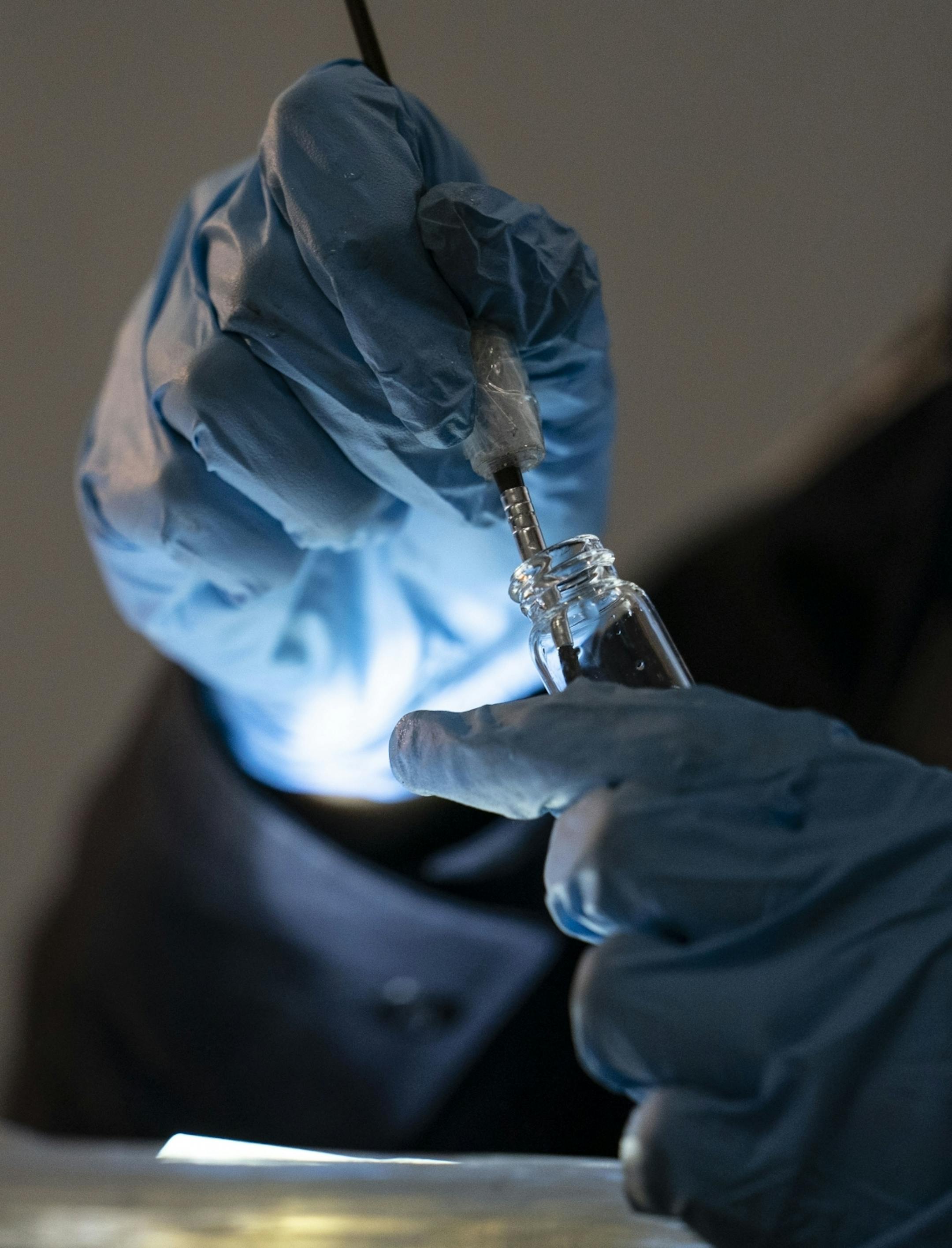 A U.S. Customs and Border Protection agriculture specialist pulled a bug off of a box to be sent in for analysis to determine if it poses a significant risk to the goods.