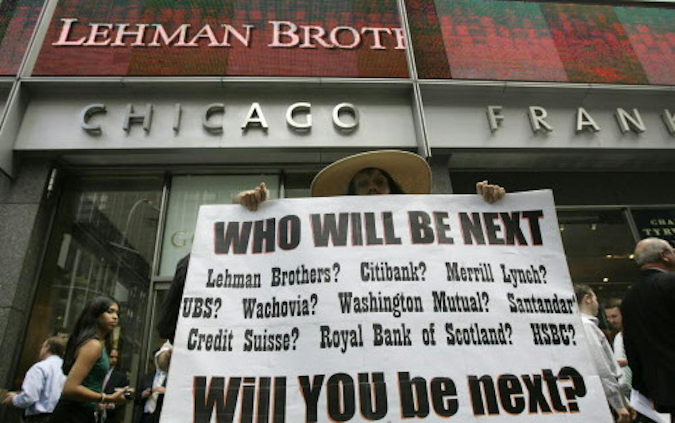 ** FOR USE SUNDAY, SEPT. 6 AND THEREAFTER ** FILE - In this Monday, Sept. 15, 2008 file photo, Robin Radaetz holds a sign in front of the Lehman Brothers headquarters in New York. That day, Lehman Brothers, a 158-year-old investment bank choked by the credit crisis and falling real estate values, filed for Chapter 11 protection in the biggest bankruptcy filing ever. (AP Photo/Mary Altaffer, file) ORG XMIT: MIN2013090915040965