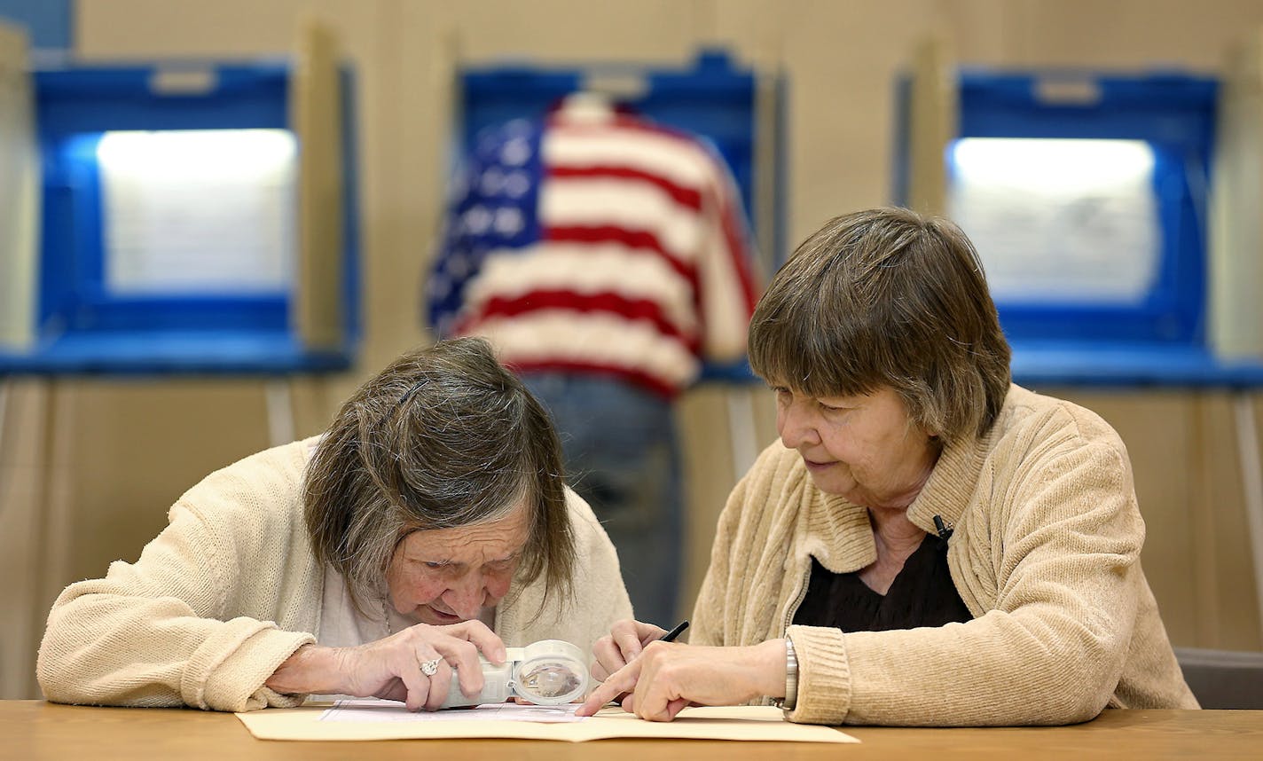 Mary Lou Hill, who will be 100 years old next week, got assistance from her daughter Sue Hill as she voted in Minneapolis on Tuesday.