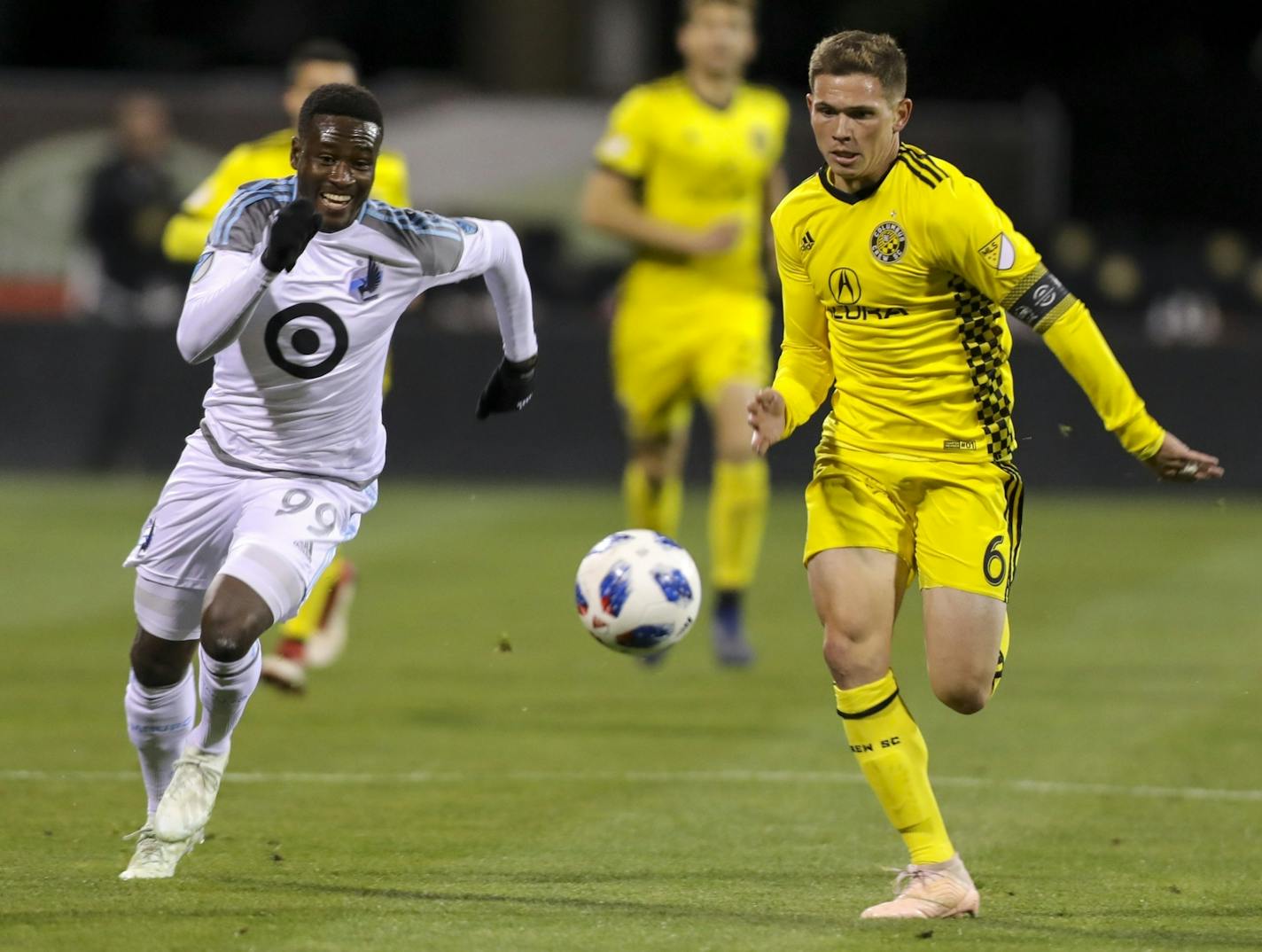 Minnesota United forward Abu Danladi and Columbus Crew SC midfielder Wil Trapp race after the ball in the second half of a game last season.