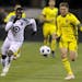 Minnesota United forward Abu Danladi and Columbus Crew SC midfielder Wil Trapp race after the ball in the second half of a game last season.