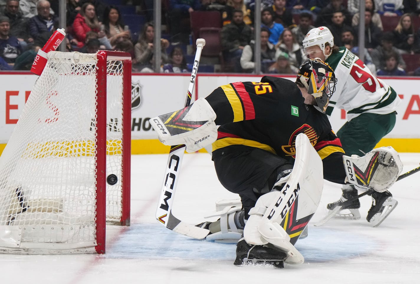 Minnesota Wild's Kirill Kaprizov, right, scores his second goal against Vancouver Canucks goalie Thatcher Demko, during the second period of an NHL hockey game Thursday, March 2, 2023, in Vancouver, British Columbia. (Darryl Dyck/The Canadian Press via AP)