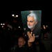 A demonstrator holds up a poster of the late Iranian Revolutionary Guard Gen. Qassem Soleimani, who was killed in a U.S. drone attack in 2020 in Iraq,