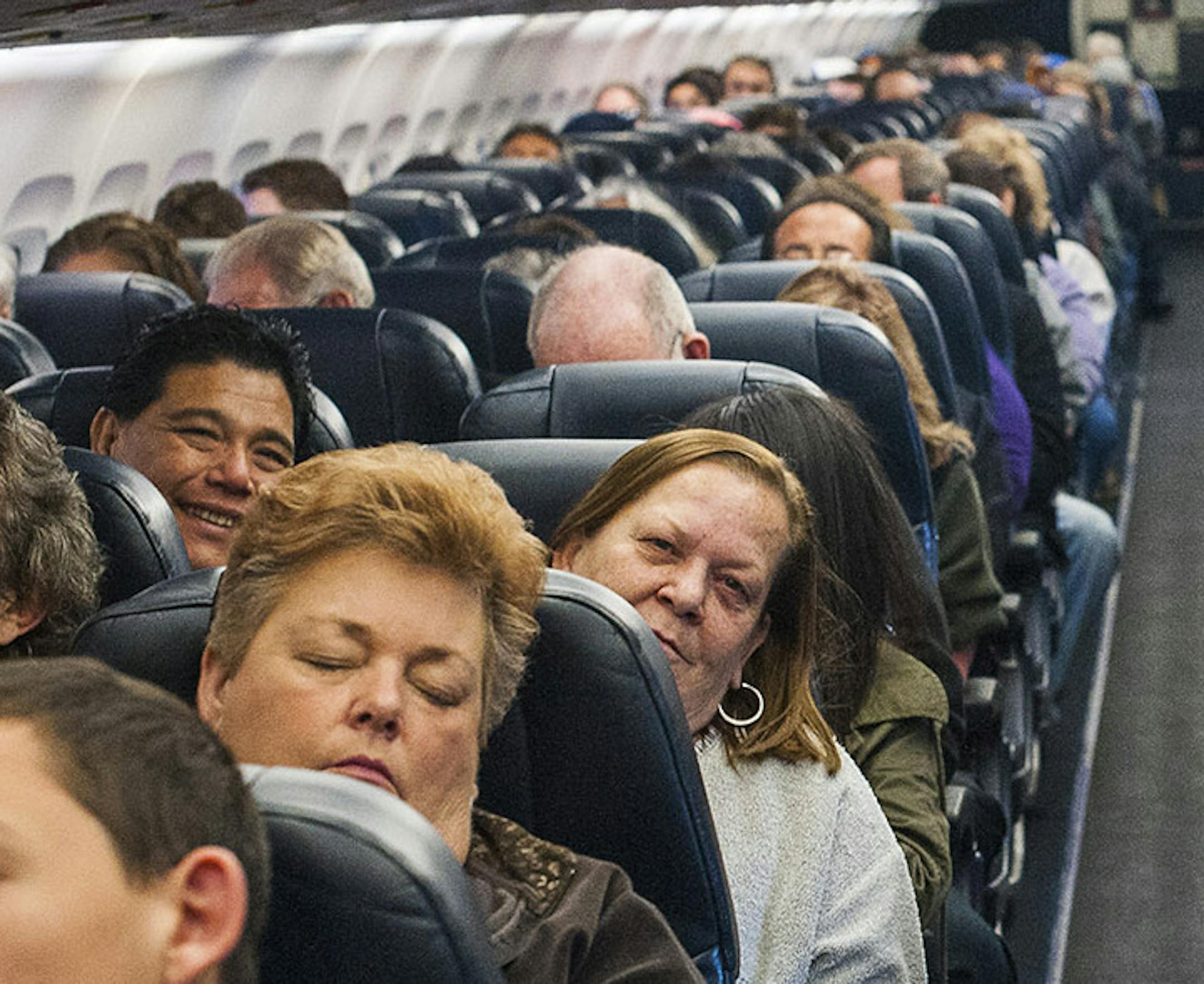 Passengers aboard an Allegiant Airlines flight en route from Las Vegas to Colorado Springs, Colo., Dec. 19, 2013. To gain a little more space between seats in the continuing push to add passengers, airlines like Allegiant, which uses seats that do not recline, are turning to a new generation of seats that use lighter materials and less padding. (Joe Giron/The New York Times) ORG XMIT: MIN2013122315411997