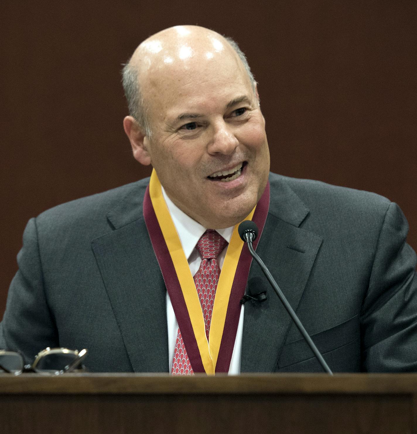 FILE - In this March 1, 2017, file photo, Elon Trustee Louis DeJoy is honored with Elon's Medal for Entrepreneurial Leadership in Elon. N.C. Mail deliveries could be delayed by a day or more under cost-cutting efforts being imposed by the new postmaster general, DeJoy. The plan eliminates overtime for hundreds of thousands of postal workers and says employees must adopt a " different mindset" to ensure the Postal Service's survival during the coronavius pandemic. (Kim Walker/Elon University via