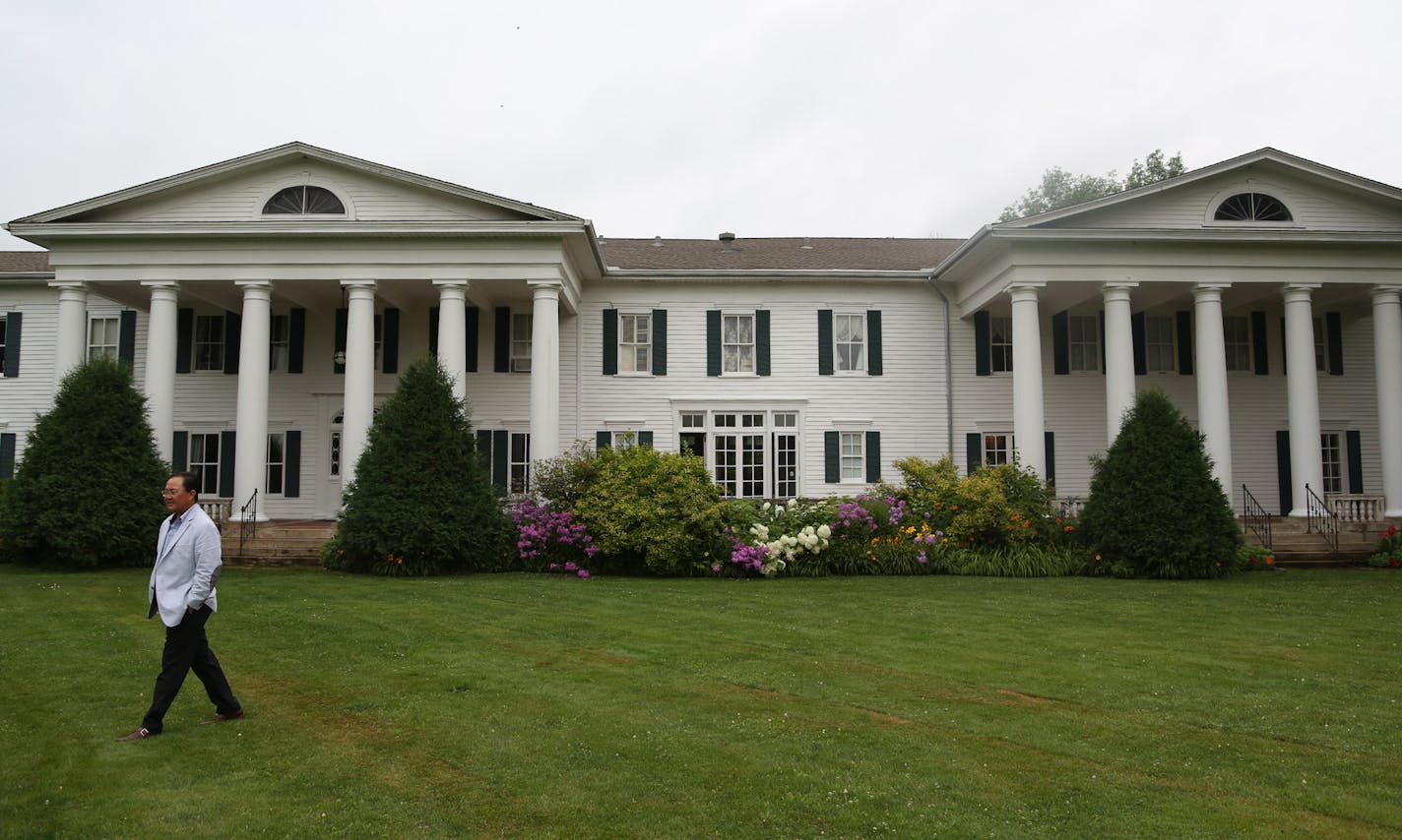 Co owner True Thao walked around the front yard at Cedarhurst Mansion. ] (KYNDELL HARKNESS/STAR TRIBUNE) kyndell.harkness@startribune.com At Cedarhurst Mansion in Cottage Grove, Min., Thursday, July 16, 2015.