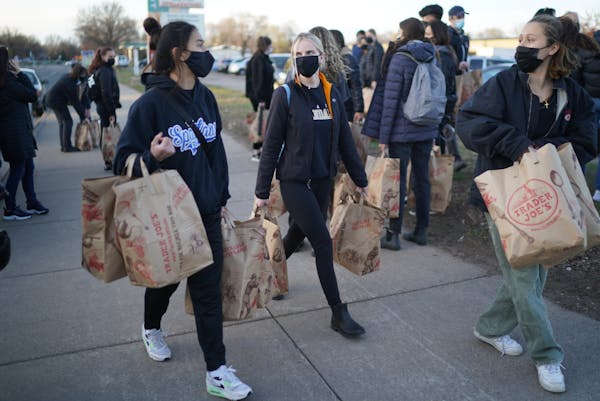 Macalester students Zoe Frederick, Elise Gryler and Sara Gregor delivered donated groceries in Brooklyn Center on Friday and asked local residents wha