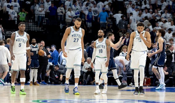 Timberwolves Anthony Edwards (5), Rudy Gobert (27), Mike Conley (10) and Karl-Anthony Towns (32) walked off the Target Center court at the end of Game