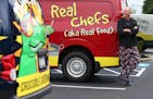 Kurt Linneman, chef and owner of Crocodile Cafe & Catering, poses with his colorful delivery trucks on July 14, 2015 in Wayne, Pa. (David Maialetti/Ph