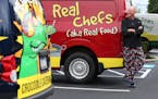 Kurt Linneman, chef and owner of Crocodile Cafe & Catering, poses with his colorful delivery trucks on July 14, 2015 in Wayne, Pa. (David Maialetti/Ph