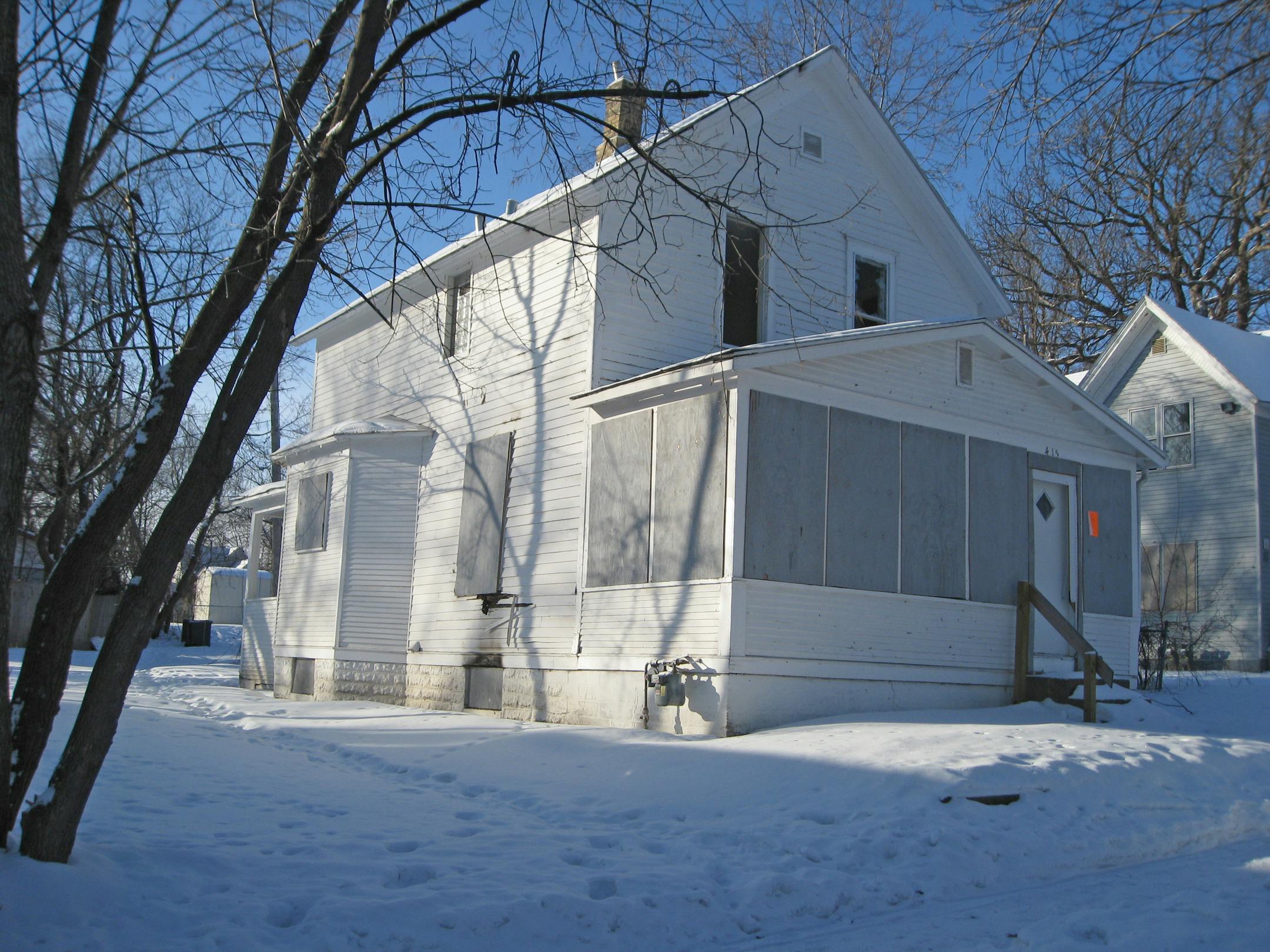 This house at 415 31st Ave. N. is the subject of a potentially groundbreaking lawsuit that seeks to hold lenders responsible for careless loans. Windows on the second floor are broken.