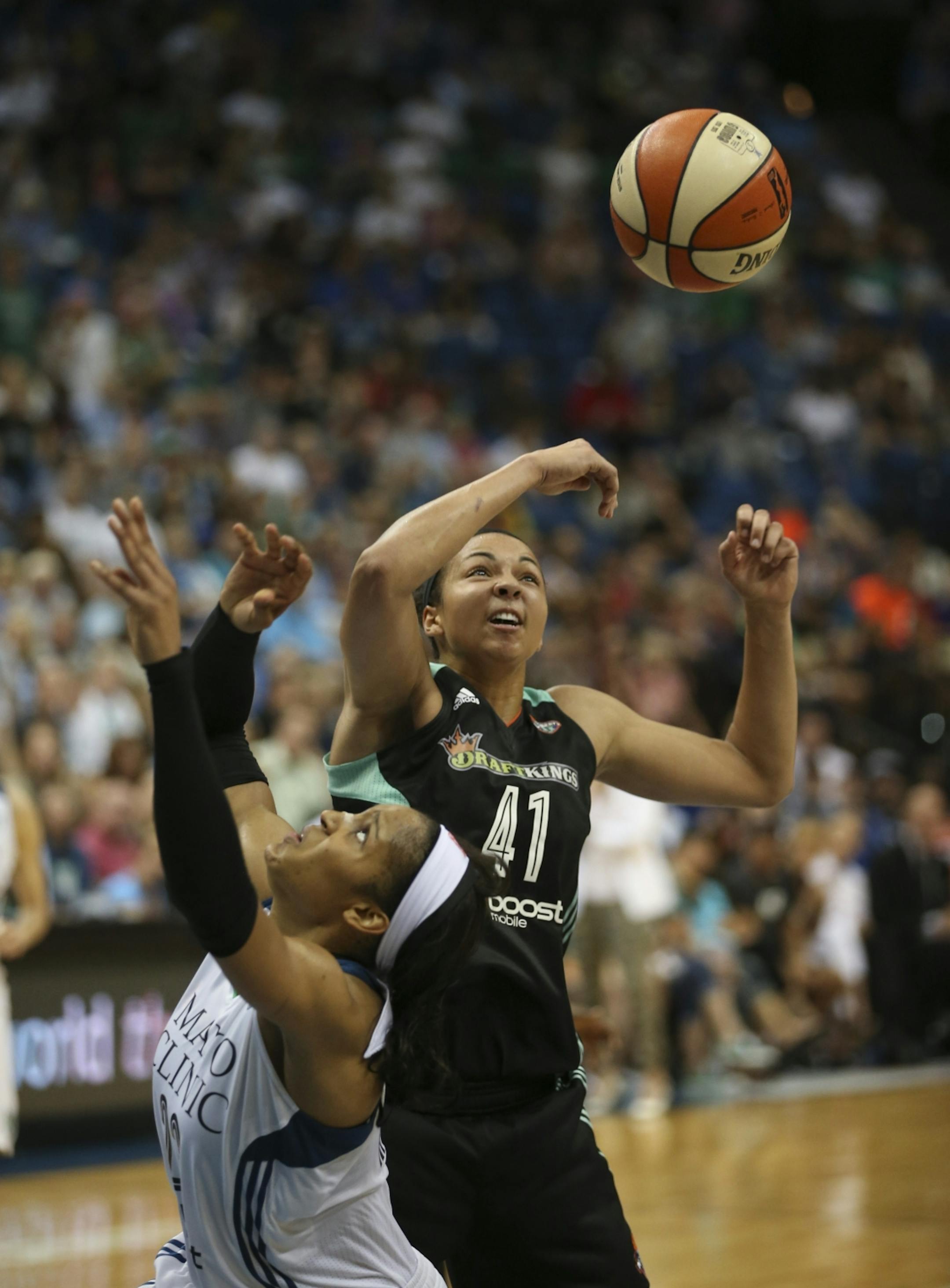 Minnesota Lynx forward Maya Moore (23) was stripped of the ball by New York Liberty center Kiah Stokes (41) as she drove to the net late in the fourth quarter Sunday night.