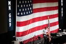 A technician set up the stage for the GOP state convention, May 12, Rochester, Minn. Candidates hung signs as the stage was being prepared for that we