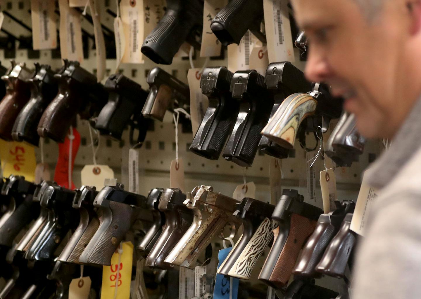 Rick Boelter, a firearm's examiner in the Hennepin County Sheriff's Office, is in the firearms reference collection vault, where guns used in the commission of a crime in solved cases are stored.