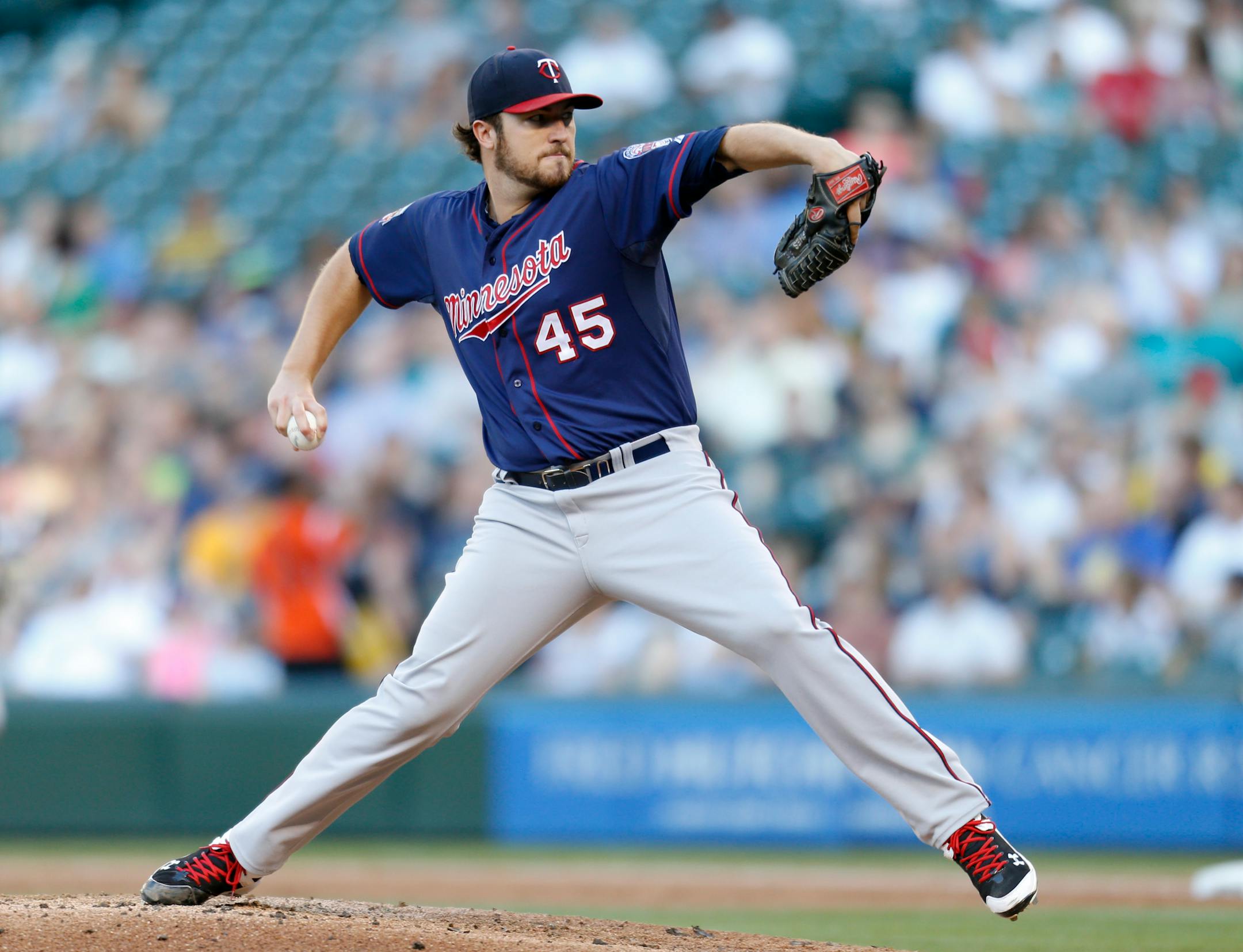 Minnesota Twins starting pitcher Phil Hughes throws against the Seattle Mariners during the first inning of a baseball game on Tuesday, July 8, 2014 in Seattle. (AP Photo/John Froschauer)