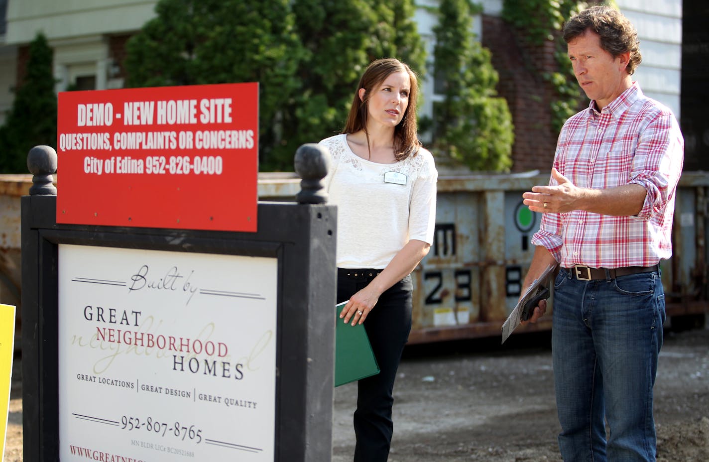 Residential Redevelopment Coordinator for the City of Edina, Cindy Larson, speaks with Scott Busyn, the owner of Great Neighborhood Homes at a new home construction site in Edina, Minn., on Thursday, July 11, 2013. Larson is a mediator between home builders and neighbors. "My job is part construction, part counselor," she said. ] (ANNA REED/STAR TRIBUNE) anna.reed@startribune.com (cq)