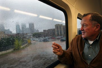 Roger Scherer, photographed riding the then-new Northstar commuter rail line in 2009, was a Metropolitan Council member.