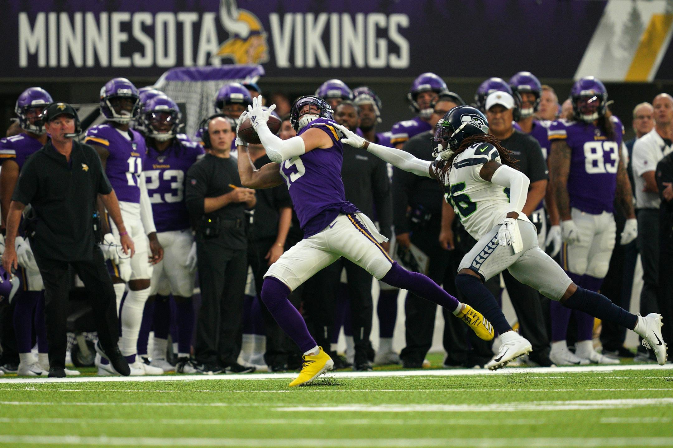 Minnesota Vikings wide receiver Adam Thielen (19) completed a long pass from Minnesota Vikings quarterback Kirk Cousins (8) as Seattle Seahawks cornerback Shaquill Griffin tried to defend in the first half.