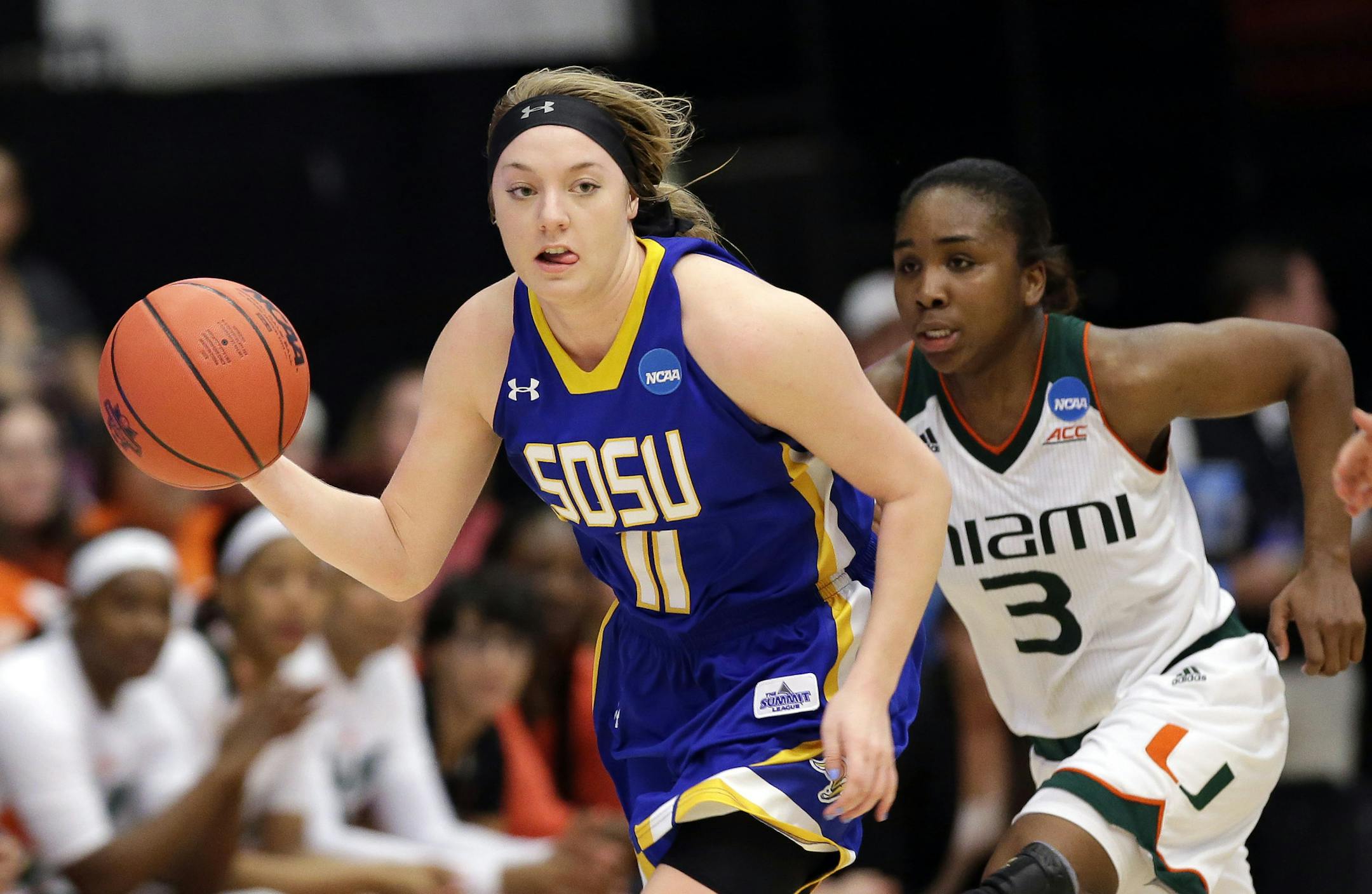 South Dakota State guard Madison Guebert (11) dribbles past Miami guard Jessica Thomas (3) in the second half of a first-round women's college basketball game in the NCAA Tournament Saturday, March 19, 2016, in Stanford, Calif. South Dakota State won 74-71. (AP Photo/Marcio Jose Sanchez)