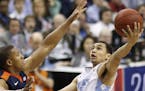 North Carolina guard Marcus Paige shoots against Virginia guard Devon Hall during the second half of an NCAA college basketball game for the champions