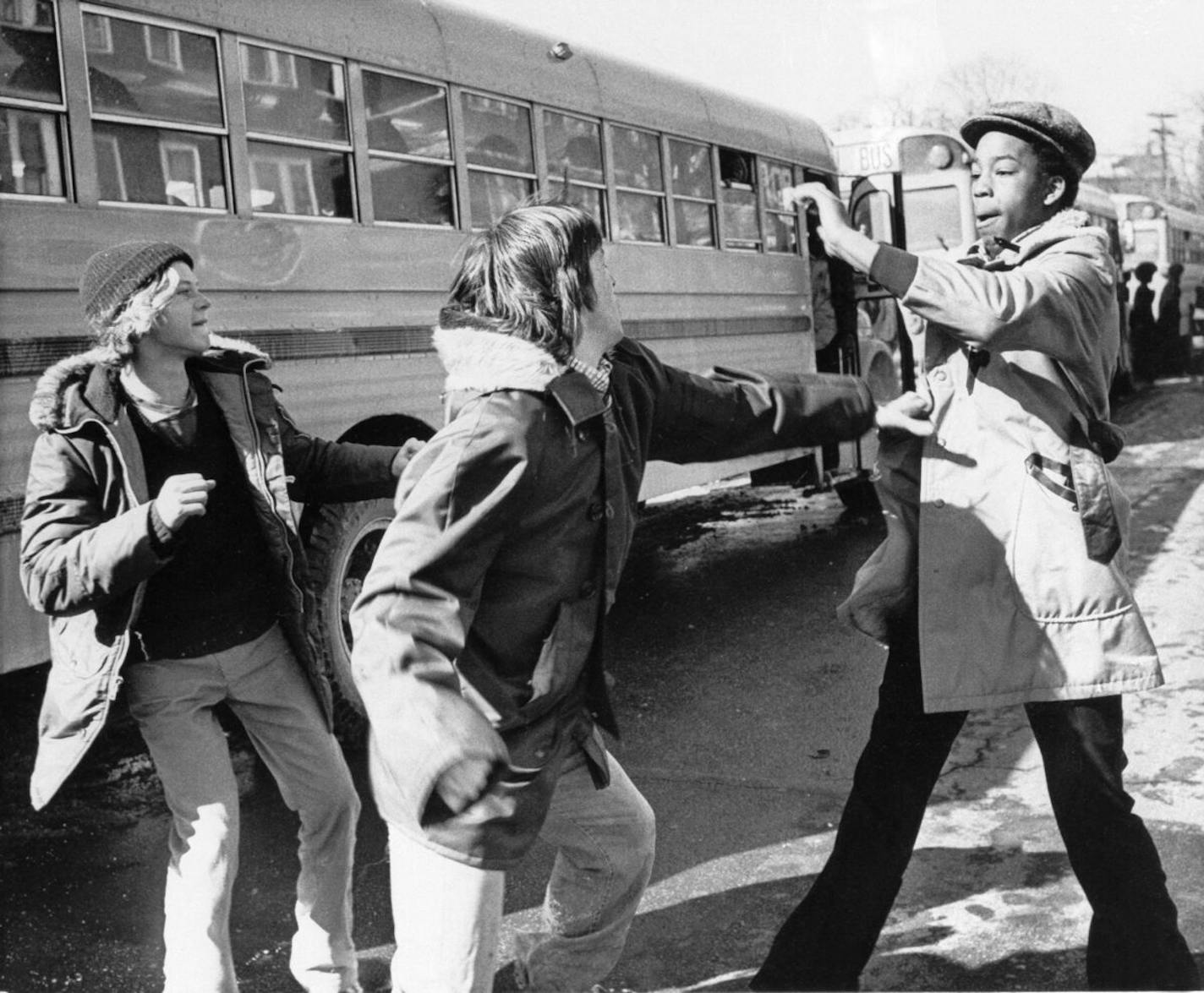 White and black students begin to fight outside Hyde Park High School in Boston, Mass., Feb. 14, 1975. The city of Boston started a court-ordered school integration program requiring the busing of 18 percent of public school students. (AP Photo/DPG)